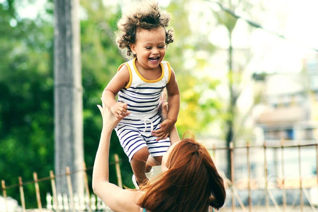 baby laughing with mom